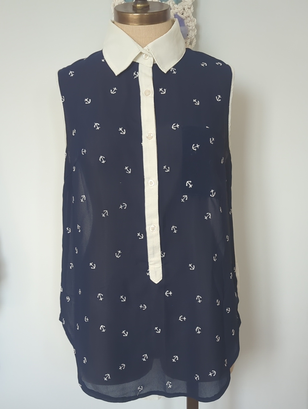 Navy blue and white sleeveless sheer blouse with buttons and front pocket size M